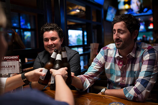 guys cheering beer at miller's ale house