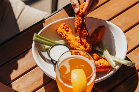 a plate of tenders and a beer