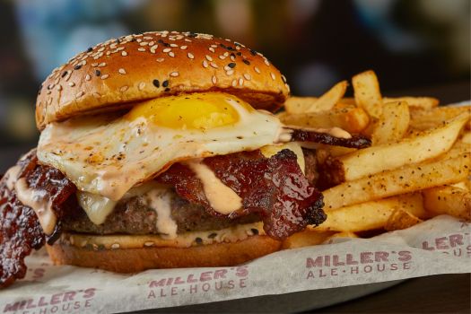 a brunch burger from millers ale house with a side of fries