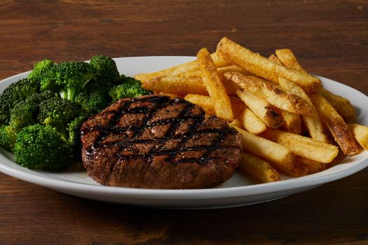 a plate of sirloin with broccoli and fries