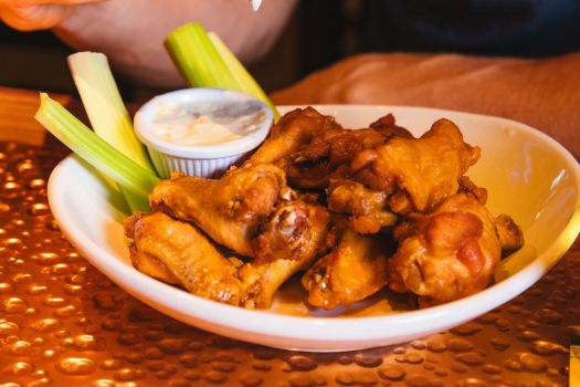 a plate of chicken wings and celery