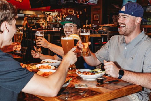 group of guys cheersing their beers