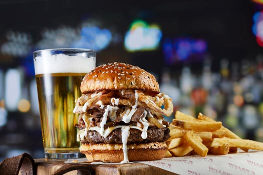 a prime burger with fries and a beer