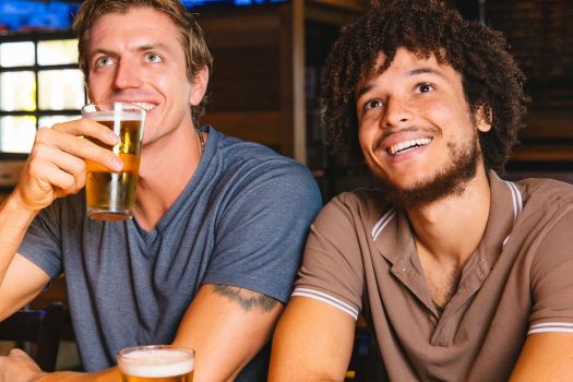 two guys enjoying and watching the game