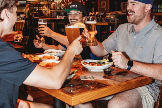 group of guys cheersing their beers